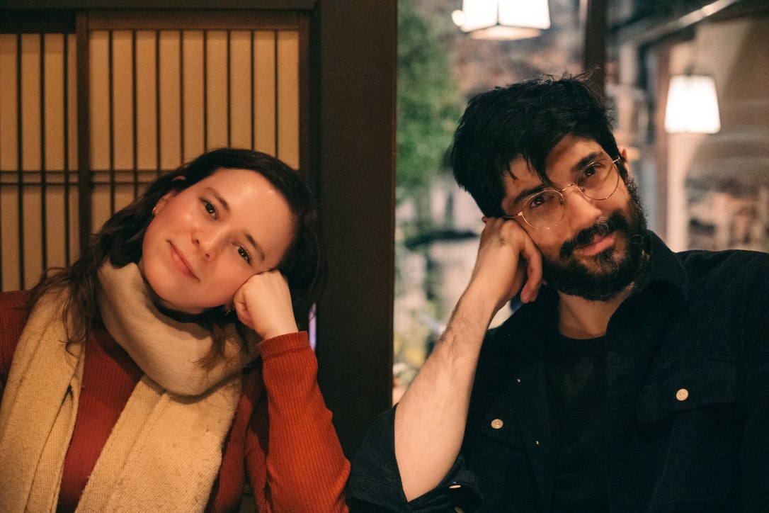 a photo of amit and blake smiling at the camera at a bar in japan